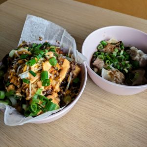 bowl of bulgogi tots and bowl of dumplings