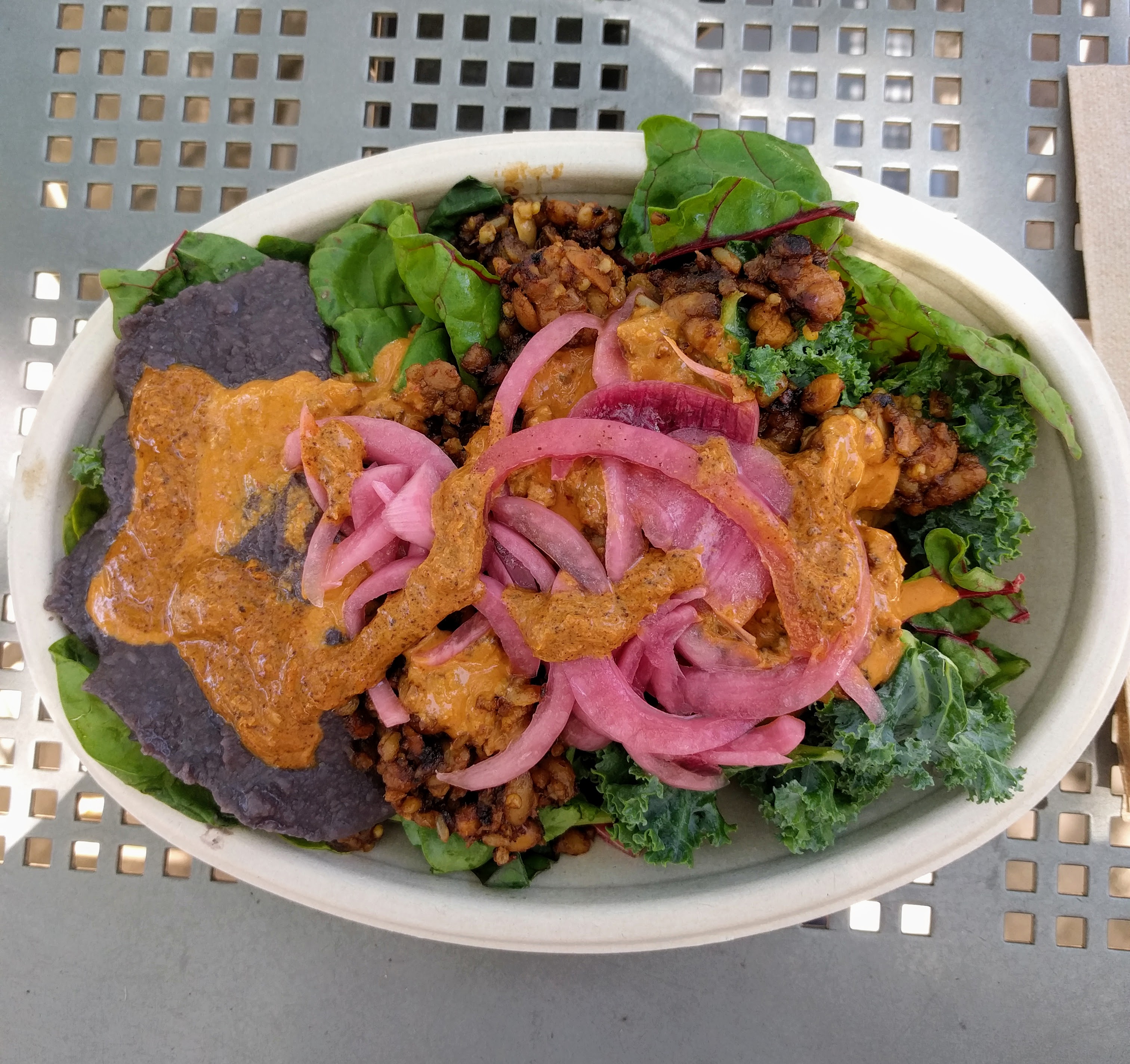 Salad with tempeh, sauces, and pickled red onions