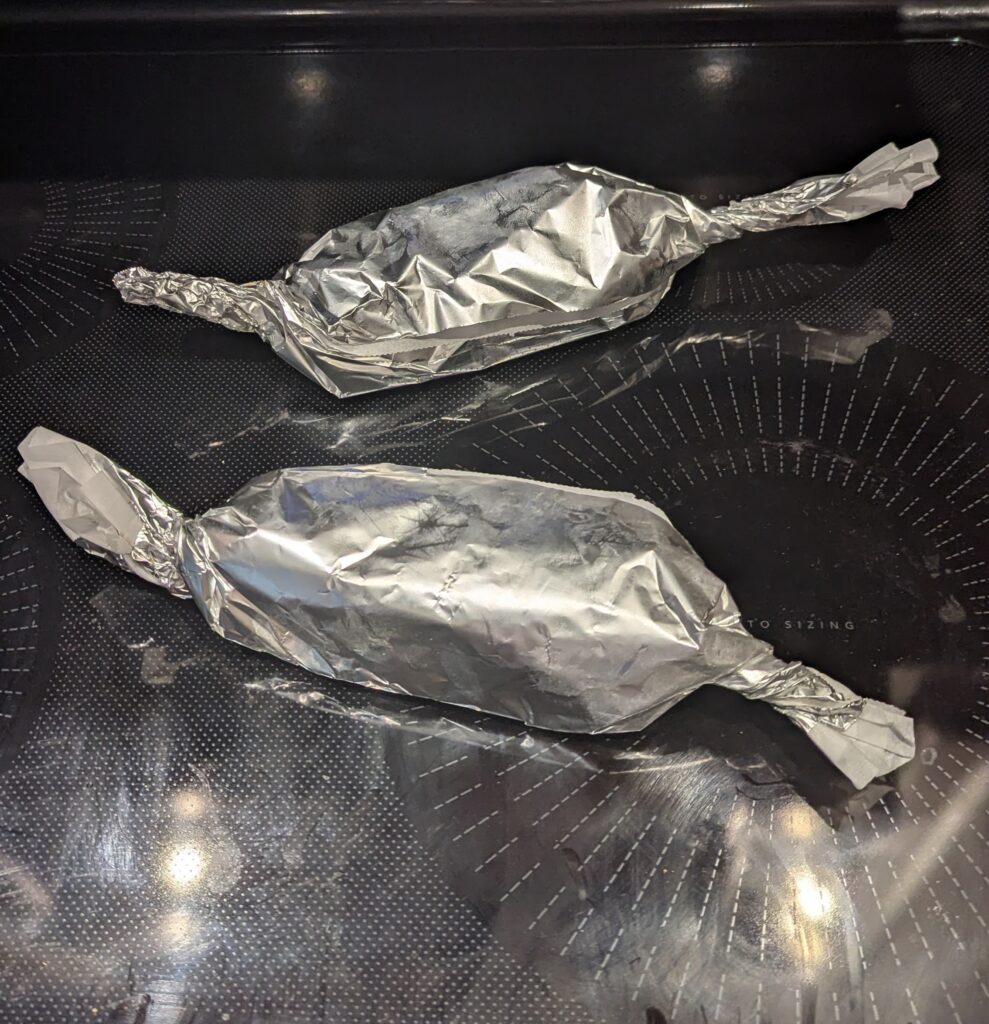 Two ten inch long foil packets with twisted ends.